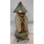 An Arts and Crafts hand beaten copper electric heater with four elements, crowned with a pyramid