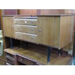 A Nathan teak dressing table with shallow drop well over other three central drawers flanked by