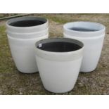 Stack of six painted moulded plastic Cortina Stone garden planters of circular tapered form, 58cm