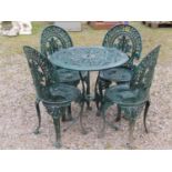 A green painted cast aluminium garden terrace table of circular form, together with a set of four