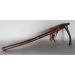 An antique Indigenois people leather clad hunting weapon. 57cm