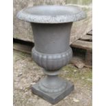 A small cast iron urn with flared rim, lobed body and square cut base, 32 cm diameter x 43 cm high