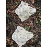A pair of cast composition stone grotesque face masks, 35 cm