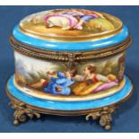 A 19th century French porcelain casket of oval form with hand painted repeating character and