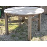 Pamal weathered teak garden table of circular form with slatted top, 113cm diameter, raised on