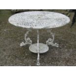 A cream painted cast aluminium two tier garden terrace table of circular form, with decorative