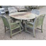A good quality weathered teak D end extending garden table with single additional bi-fold leaf and
