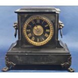 A mid-Victorian black slate mantle clock with eight day striking movement, with lion mask and