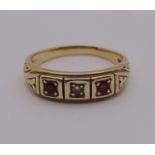 Early 21st century 9ct ruby and diamond gypsy ring, size P, 3.4g