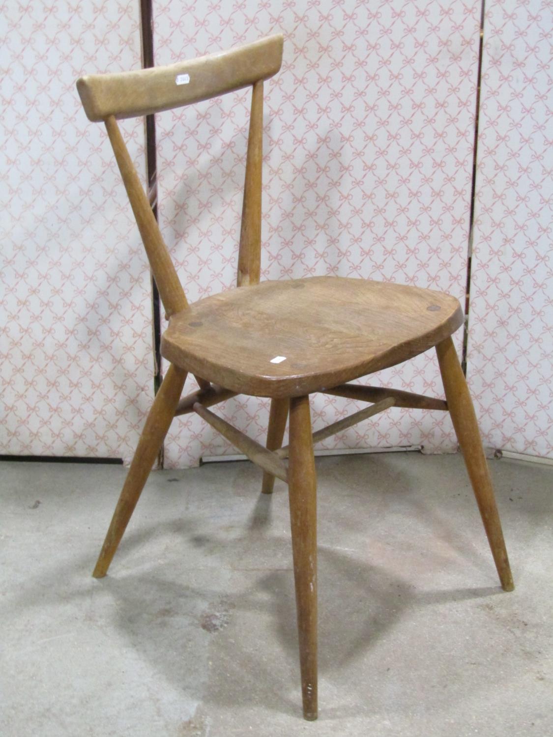 A vintage Ercol elm and beechwood stacking chair