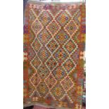 A Chobi kilim carpet, with a multi coloured diamond pattern. 198cm x 123cm.