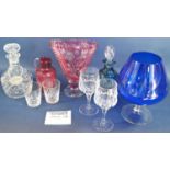 Eight modern cut glass wine glasses, a large blue brandy glass, a Bohemian style V shaped vase, a