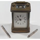 A small brass carriage clock time piece, a silver mounted pencil and silver mounted tooth pick (3)