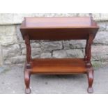 A Georgian style mahogany two tier book trough/stand with shaped outline and supports