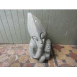 A contemporary polished stone sculpture/group of a pair of entwined pointed head characters and