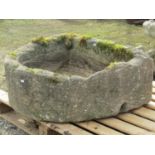 A weathered natural stone D shaped trough approximately 80 cm wide x 80 cm deep x 35 cm high