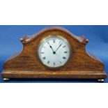 A small Edwardian oak mantle clock with inlaid detail and eight day timepiece