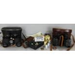 A miscellaneous collection of items, three pairs of binoculars, a vintage leather bound John