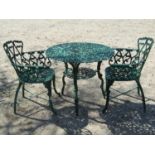 Green painted cast alloy three piece garden terrace set comprising circular top table and a pair
