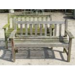 A pair of Lister weathered teak two seat garden benches with slatted seats and backs (af) 128cm wide
