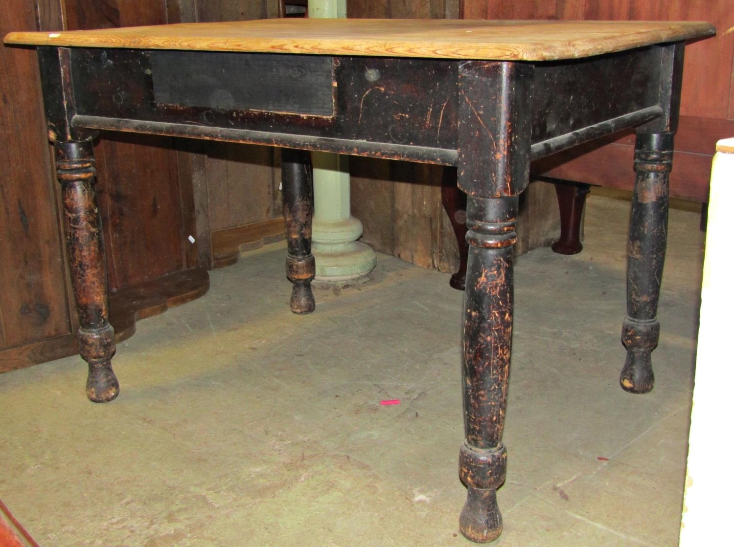 A pine kitchen table with scrub top on four turned supports, 105 cm wide