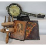 An Asprey black leather wallet, two leather folders, a banjo type instrument and a wooden clamp.