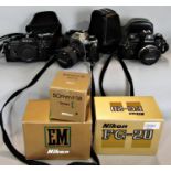 A selection of three Nikon SLR film cameras to include - FG 20 C/W zoom Nikkor 35-70mm/f3.5-4.8