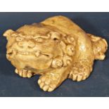 A Chinese Temple Lion, hand moulded with uniform glazed finish, to the base a label Period of
