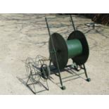 A vintage portable green painted iron work two wheeled hose reel with wooden handle 98 cm high x