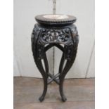 A Chinese hardwood jardiniere stand with carved and pierced detail and inset marble top, 68 cm in
