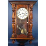 A late 19th century wall clock, the case with split spindle mouldings, with eight day striking