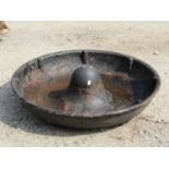 A vintage Mexican hat shaped cast iron circular pig feeding trough, 74cm diameter approx (af)