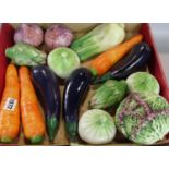 A collection of ceramic vegetables, carrots, aubergine, onions, fennel, etc.