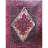 A Senneh rug with stepped lozenge shaped central panel decorated with stylised flowers, 145cm x