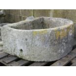 A weathered natural stone D shaped trough 75 cm wide x 63 cm deep x 32 cm high