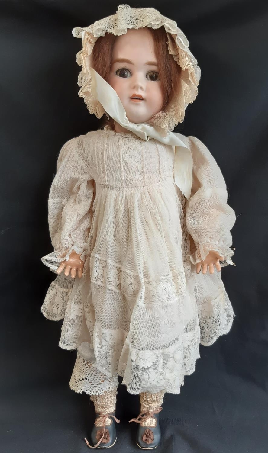 Early 20th century bisque head doll with jointed composition body, closing brown eyes, open mouth