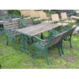 A five piece garden suite with decorative green painted open scrolling foliate pattern cast iron end