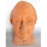 A clay bust of a woman?s head. 28cm high