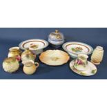 A collection of ceramics comprising two low comports with green and gilt banding and floral