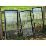 Four reclaimed heavy gauge galvanised steel framed windows with leaded light panels, the largest 100