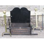 A pair of Old English brass and iron firedogs supporting an ironwork fire basket, 88cm wide x 35cm