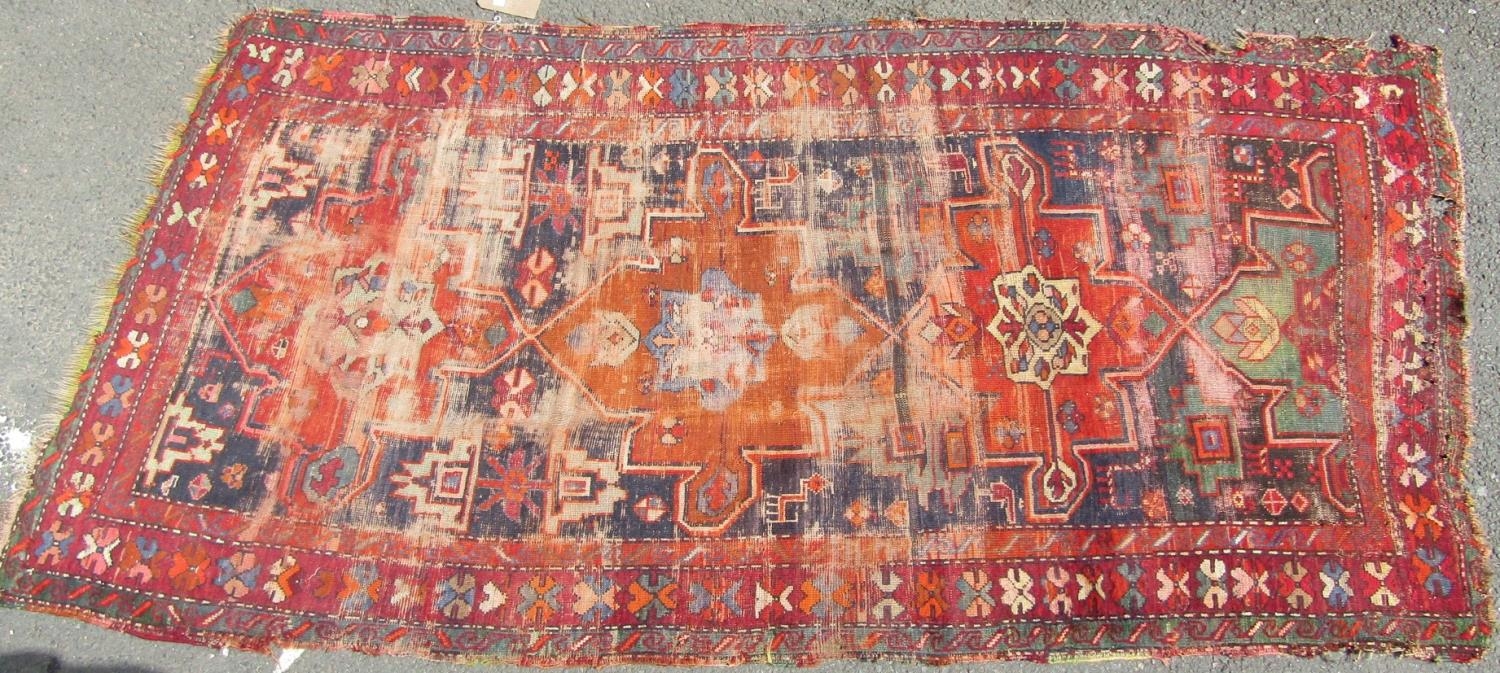 An old Persian rug with a central orange medallion,245cm x 120cm approx - Image 2 of 4