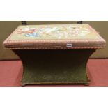 A Victorian rectangular box ottoman, with concave sides, hand worked needle point top on bun feet,