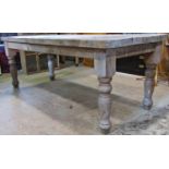 A stripped pine farmhouse kitchen table with thick rectangular top, raised on turned supports, 213cm