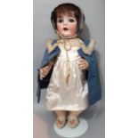 A Kestner bisque head character baby doll, with blue lashed sleeping eyes, bent-limbed composition