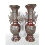 A pair of early 20th century Japanese bronze vases with exotic bird handles. 39cm high