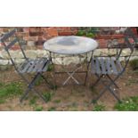 A contemporary three piece folding bistro set comprising circular top table, pair of matching chairs