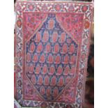 A Persian design carpet with a central medallion of botehs within a stylised floral border, 180cm