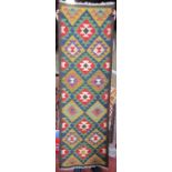 A Maimana Kilim runner with a repeating large multi coloured diamond pattern. 194cm x 63cm approx.