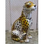 A ceramic leopard in seated pose 75 cm in height